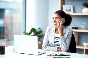 Entrepreneur starting an LLC online while working on a laptop in a modern office.