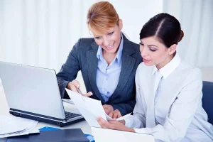 Business owners reviewing LLC ownership documents while adding a new member to an existing LLC