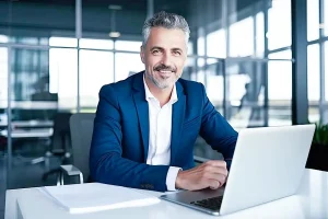Business owner working at a laptop while evaluating LLC vs sole proprietorship business structure options for liability protection and growth