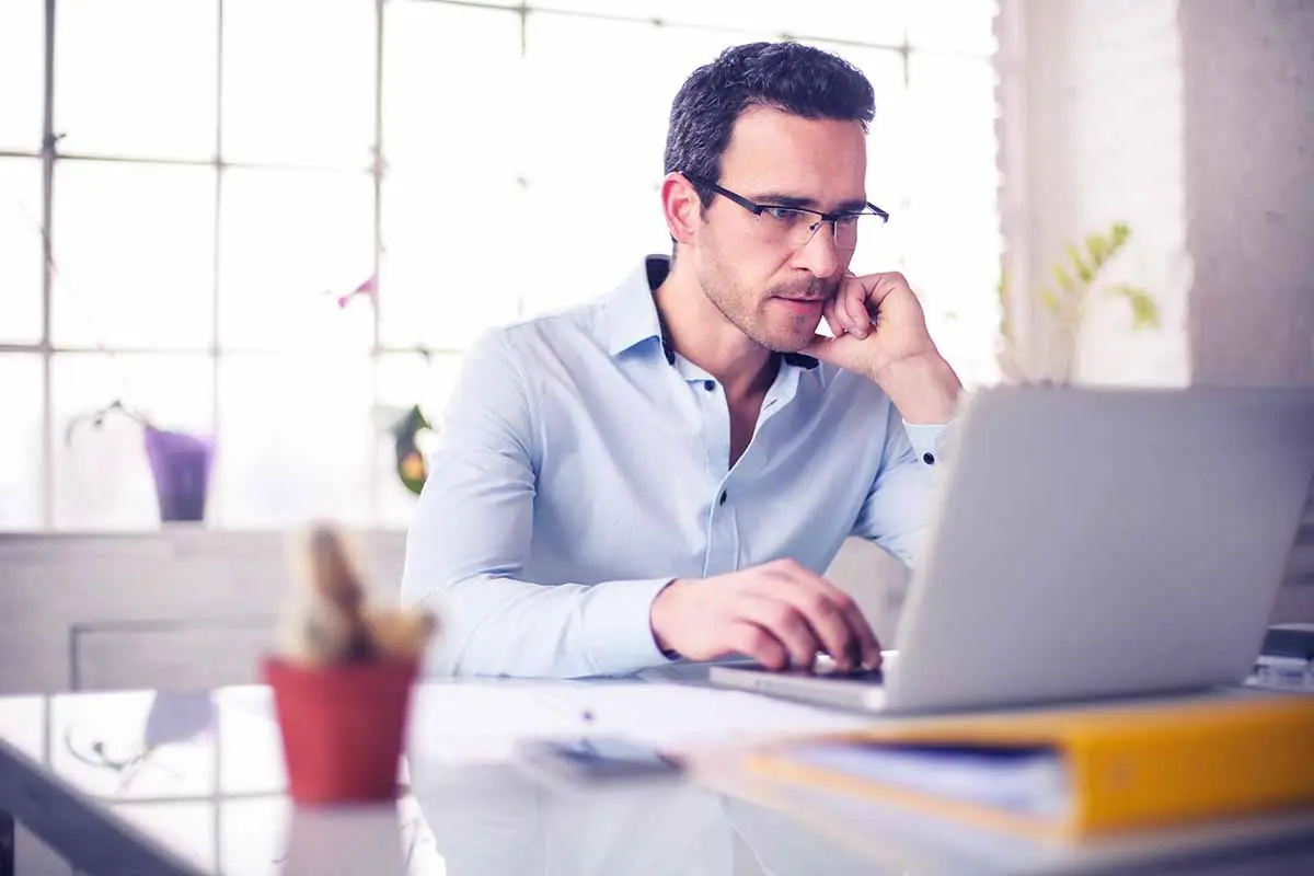 Business owner researching the best state to form an LLC on a laptop before starting a new business